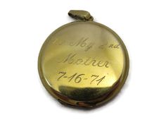 "A lovely vintage gold locket. It's 12kt gold fill, and has etched flowers and flourishes on the front. Inside there two spots for photos. On the back, it reads \"To My 2nd Mother 7-16-71\". Marked \"1/20 12kt GF\". Measures about 1.5\" across and has minor wear appropriate for age (some small scratches). The photo frame inside is bent. I am always happy to answer any questions or send more photos when needed. Thanks for shopping Vintage In Bloom! www.facebook.com/vintageinbloom More pendants &a 14k Stamped Medallion Locket Necklace For Anniversary, Stamped 14k Medallion Locket Necklace For Anniversary, Stamped 14k Gold Medallion Locket Necklace For Anniversary, 14k Gold Stamped Medallion Locket Necklace For Anniversary, Vintage Yellow Gold Memorial Locket Necklace, Antique 14k Stamped Locket Necklace For Anniversary, Vintage Stamped 14k Locket Necklace For Wedding, Vintage Yellow Gold Locket Necklace For Memorial, Vintage 14k Stamped Locket Necklace For Wedding