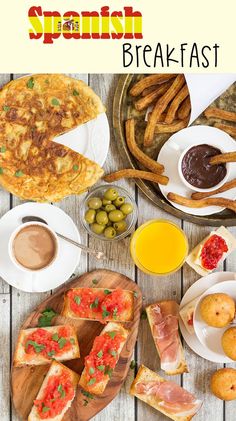 the spanish breakfast is ready to be eaten on the table with bread, olives and other foods