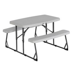 two white plastic picnic tables sitting next to each other