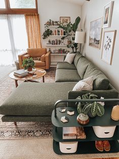 a living room filled with lots of furniture and plants on top of a coffee table