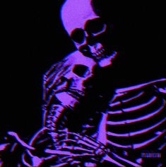 a skeleton sitting down in the dark