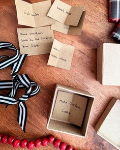 several small boxes are sitting on a table with ribbons and tags attached to the box