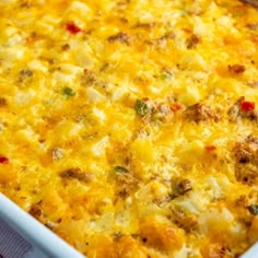 a casserole dish with meat, cheese and vegetables in it on a table