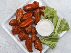 chicken wings with celery and ranch dressing on a plate