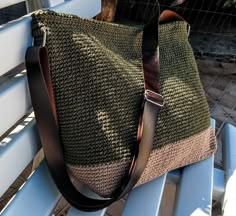 a purse sitting on top of a blue bench