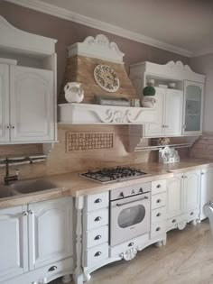 a kitchen with white cabinets and an oven