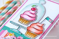 a birthday card with cupcakes on it and candy sticks in the back ground