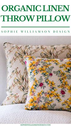 the organic linen throw pillow is shown with yellow flowers on it and green lettering that reads,