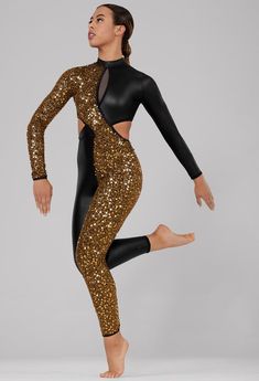 a woman in black and gold glitter bodysuit with her legs crossed, standing on one leg