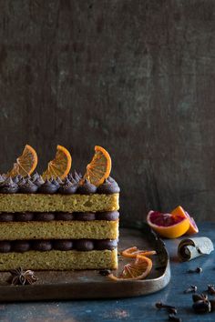 a piece of cake with chocolate frosting and orange slices