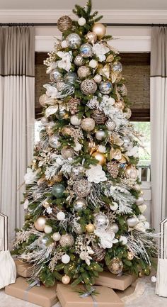 a christmas tree decorated with gold and silver ornaments