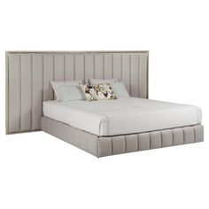 a bed with a white headboard and two pillows on it's sides, in front of a white background