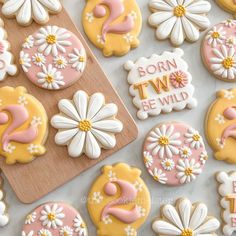 decorated cookies with the words born to be wild on them and daisies next to each other