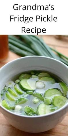 a white bowl filled with soup next to green onions