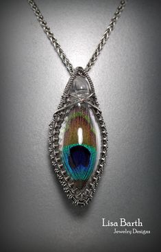 Lisa Barth - This beautiful little bottle has a peacock feather suspended within.  I have woven a frame around it using sterling gallery wire.  You can learn to us gallery wire with your own centerpieces.  Here is the tutorial: Silver Teardrop Jewelry In Copper Wire, Silver Teardrop Jewelry With Copper Wire, Unique Wire Wrapped Teardrop Pendant Jewelry, Fusion Style Wire Wrapped Pendant Jewelry, Handmade Wire Jewelry For Jewelry Making, Handmade Silver Wire Jewelry, Unique Handmade Wire Jewelry, Wire Wrapped Oval Metal Jewelry, Oval Wire Wrapped Metal Jewelry