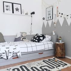 a bedroom with a bed, rug and pictures on the wall