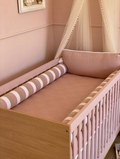 a baby crib in a pink nursery room