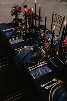 a table set with candles and place settings