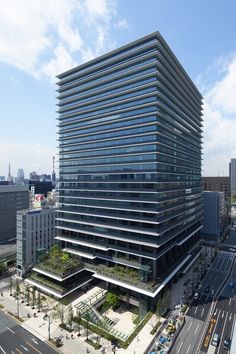 an aerial view of a large office building in the middle of a busy city street