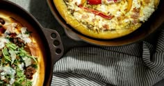 two pans filled with food sitting on top of a table next to each other