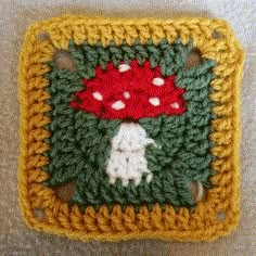 a crocheted square with a mushroom on it