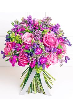 a bouquet of pink and purple flowers on a table