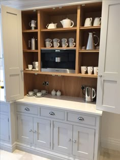 an image of a coffee maker in a kitchen with built - in cabinets and cupboards