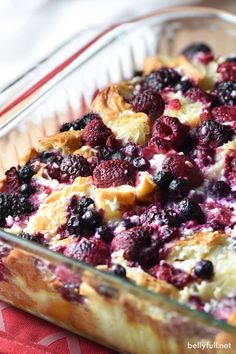 an easy breakfast croissant puff is in a glass dish on a red and white tablecloth