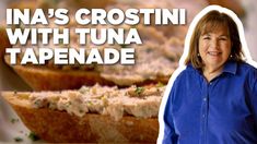 a woman standing next to some food on a plate with the words ina's crostini with tuna tapenade