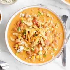 a white bowl filled with chicken and bean soup