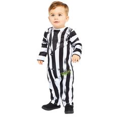 a little boy dressed in a referee costume