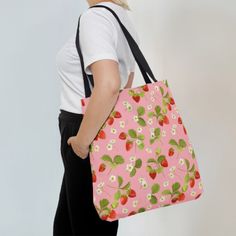 Shop in style with this pink strawberry tote bag. Available in 3 sizes to add both functionality and style, these custom-printed tote bag come with two different handle colors to choose from (black and white). Made with spun polyester, these bags feature double-stitched seams, cotton webbing straps, and nonwoven laminate lining for high-end durability. The all-over print is created with dye sublimation for vibrant and long-lasting designs. .: 3 sizes available:        13x13 inches        16x16 i Cute Farmers Market, Casual Rectangular Bag With Strawberry Print, Everyday Tote Bag With Strawberry Print, Trendy Pink Strawberry Print Bag, Affordable Strawberry Print Rectangular Bag, Strawberry Tote Bag, Pink Floral Print Shopping Bag, Spring Tote, Farmers Market Bag