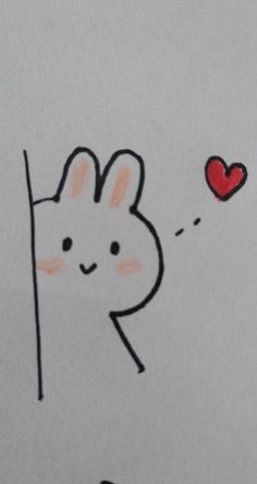 a drawing of a bunny peeking out from behind a wall with a heart on it