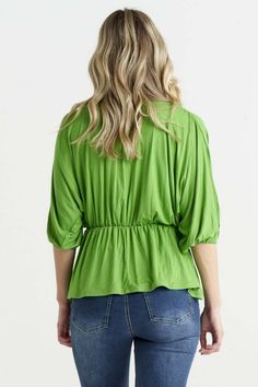 Wrap yourself in elegance with the Bayeaux Wrap Top in Artichoke. This top features a cross-over wrap at the front, creating a flattering and feminine silhouette. The V-neck adds a touch of sophistication, while the elastic cuffs on the 3/4 sleeves provide comfort and style. Made with a soft and liquid jersey fabric, this top is not only pleasing to the touch but also drapes beautifully on the body. The flattering fit with an elasticated waistline adds a chic and tailored touch. Whether you're dressing it up with a skirt for a formal occasion or pairing it with jeans for a more casual look, the Bayeaux Wrap Top in Black is a versatile and sophisticated choice that will make you feel confident and stylish.