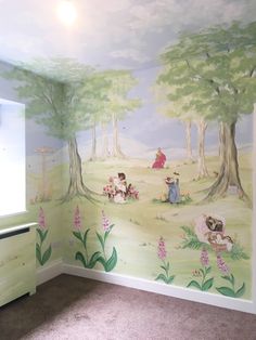 a child's room with a painted mural on the wall and carpeted floor