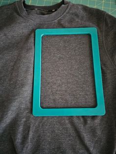 a blue frame sitting on top of a gray shirt