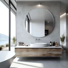 a bathroom with a large round mirror above the sink