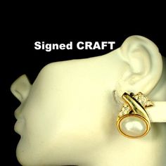 "Vintage 1980's Signed CRAFT Gold Faux Pearl Clip Ons With Rhinestones, Glam Designer Earrings 1 1/2\" long by 1\" wide ( 3.81cm x 2.54cm ) The Gold shiny metal clip earrings are signed on back by CRAFT slightly use, bno scratches on faux pearls -------------------------------------------------------------------- PLEASE NOTE I ONLY ship to your paid ETSY invoice address Please Email any questions..I answer 7 days a week, except when I am sleeping!! VINTAGESTARRBEADS www.vintagestarrbeads.etsy.co Handmade Retro Gold Clip-on Earrings, Luxury Retro Clip-on Earrings, Luxury Vintage Yellow Gold Clip-on Earrings, Luxury Vintage Clip-on Pearl Earrings, Vintage Gold Clip-on Earrings With Rhinestones, Clip Earrings, Glass Bead Necklace, Earrings Vintage, Small Jewelry