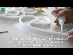 a person is working on something with white paint