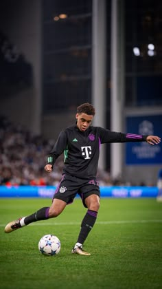 a man kicking a soccer ball on top of a field