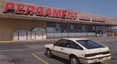 a car parked in front of a store with the word pergament on it