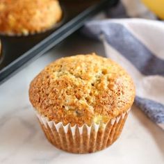 a muffin sitting on top of a counter next to some other muffins