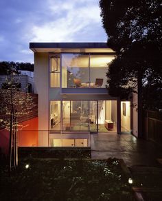 an exterior view of a modern house at night