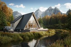 a house with a car parked in front of it next to a river and mountains