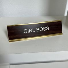 there is a sign that says girl boss on the side of a white counter top