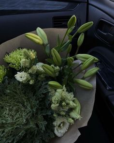 a bouquet of flowers sitting in the passenger seat of a car