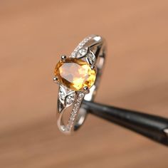 It is a natural citrine ring. The main stone is 6 mm*8 mm oval cut.weight about 1.14 carats. The basic metal is sterling silver and plated with rhodium. To change the metal to a solid gold (white/rose) or platinum is also available, please ask for a quotation if you want. You can also go to my shop Home for more elegant rings: https://www.etsy.com/shop/godjewelry?ref=hdr_shop_menu More citrine rings: https://www.etsy.com/shop/godjewelry?search_query=citrine Customization is always welcome and pl Pukhraj Ring, Tomorrow Quotes, Yellow Gemstone Ring, Topaz Wedding Ring, Citrine Ring Engagement, Elegant Rings, Blue Opal Ring, Blue Gemstone Rings, Green Amethyst Ring