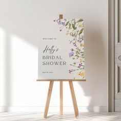 an easel stands in front of a white wall with the words hello bridal shower on it