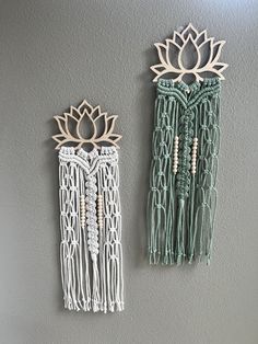 two wall hangings made out of macrame beads and wood, each with a lotus flower