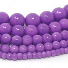 purple beads are arranged in rows on a white background